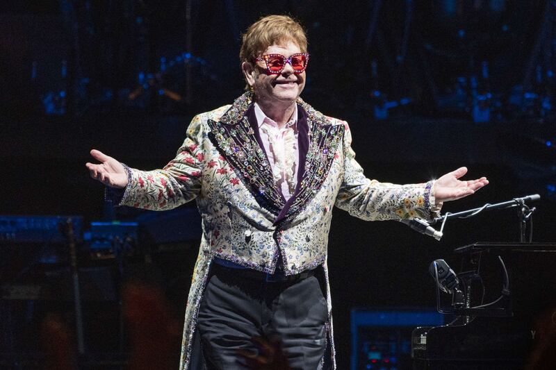 Elton John, in a white sequinned suit, performs his 'Farewell Yellow Brick Road Tour' at the Smoothie King Centre, New Orleans, Louisiana on January 19, 2022. AFP