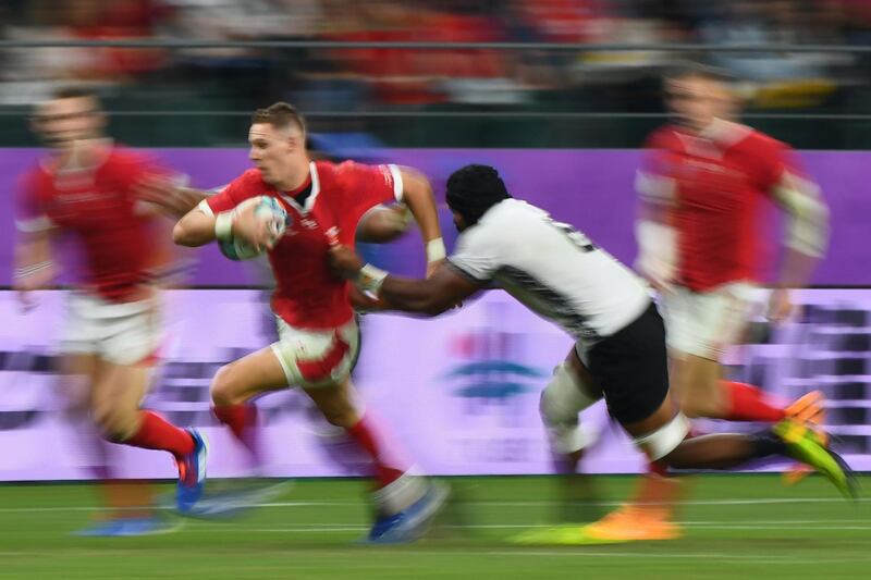 Wales' full back Liam Williams (L) runs past Fiji's flanker Dominiko Waqaniburotu during the Japan 2019 Rugby World Cup Pool D match between Wales and Fiji at the Oita Stadium in Oita. AFP