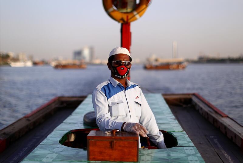 An abra driver wears protective gloves and a face mask in Dubai. Getty Images