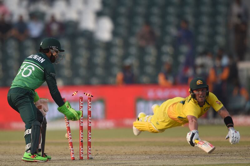 Pakistan wicketkeeper Mohammad Rizwan runs out Australia's Ben McDermott. AFP