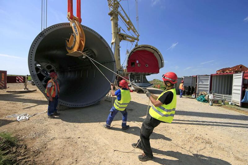 France's energy transition law seeks to gradually reduce the country's reliance on nuclear power between now and 2050, with renewable energy on centre stage. Above, the tower section of an E-70 wind turbine is lifted during its installation at a wind farm in Meneslies. Benoit Tessier / Reuters