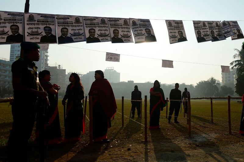 Bangladeshi voters wait in a queue to cast their vote at a polling station in Dhaka. AFP