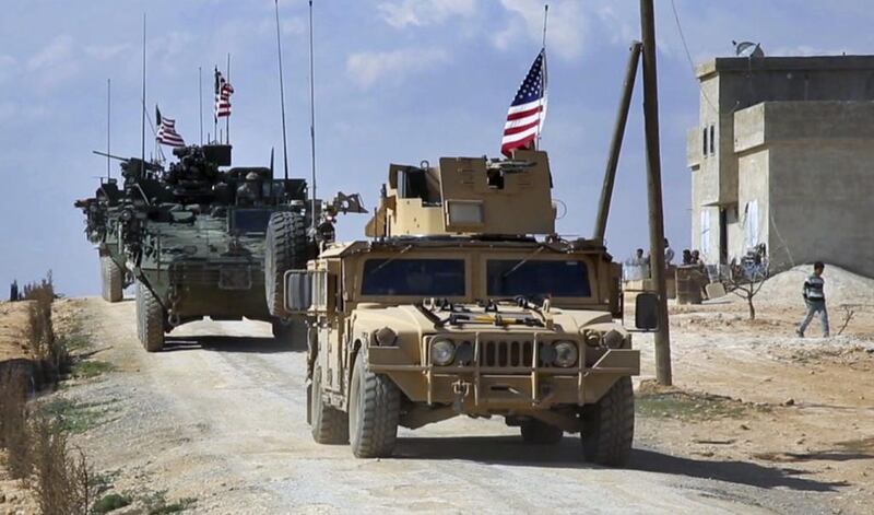 US troops patrol on the outskirts of the Syrian town, Manbij. Arab 24 network via AP Photo