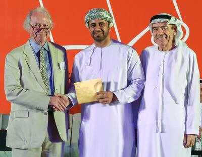 The 2023 International Prize for Arabic Fiction award winner Zahran Alqasmi, centre, with Jonathan Taylor, left and Zaki Nusseibeh, cultural adviser to the President of the UAE. Victor Besa / The National