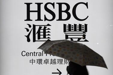 A woman walks past a Hong Kong and Shanghai Bank, (HSBC), branch in Hong Kong. The London-based bank’s Hong Kong shares slid 5.33 per cent to 29.30 Hong Kong dollars at market close on Monday. EPA