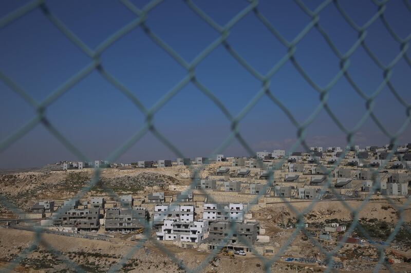 Builders work on a new housing project in the West Bank settlement of Naale. AP Photo