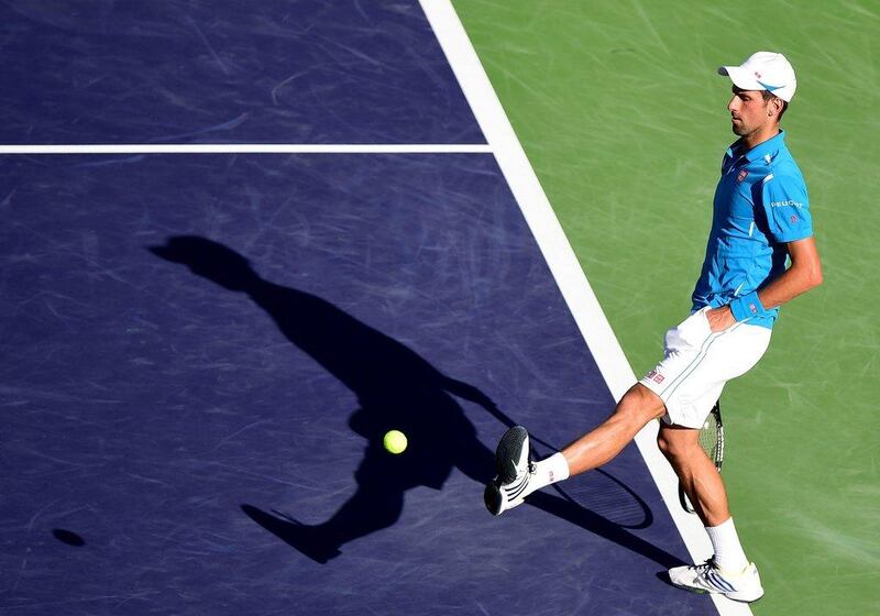 Novak Djokovic of Serbia kicks a tennis ball in a straight set win over Jo-Wilfried Tsonga of France during day twelve of the 2016 BNP Paribas Open at Indian Wells Tennis Garden on March 18, 2016 in Indian Wells, California. Harry How/Getty Images/AFP