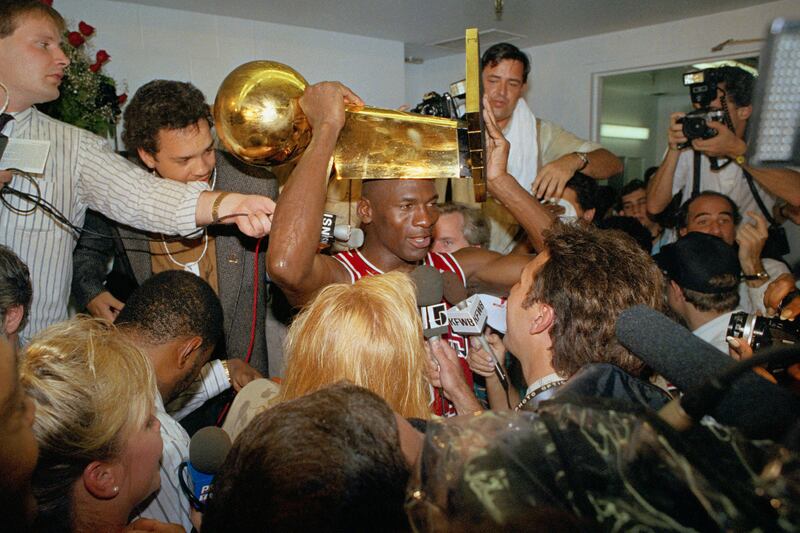 Jordan holds the NBA Championship trophy aloft after the Chicago Bulls' win against the Los Angeles Lakers at Inglewood, California. AP