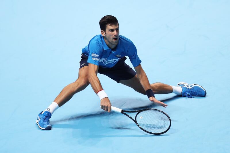 LONDON, ENGLAND - NOVEMBER 12: Novak Djokovic of Serbia stretches to play a forehand in his singles match against Dominic Thiem of Austria during Day Three of the Nitto ATP World Tour Finals at The O2 Arena on November 12, 2019 in London, England. (Photo by Naomi Baker/Getty Images)