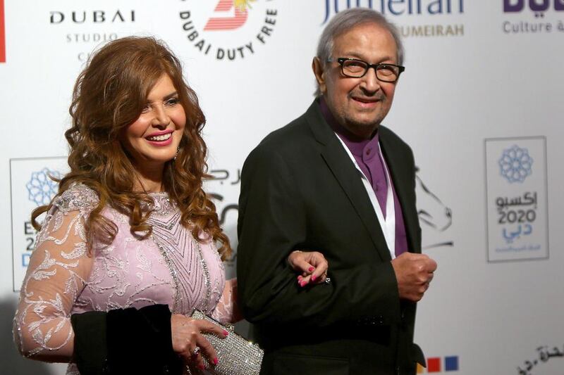 Egyptian actor Nour El-Sherif, right, and Egyptian actress Mervat Amin arrive to the opening session of the 11th Dubai International Film Festival (DIFF) in Dubai. Marwan Naamani / AFP