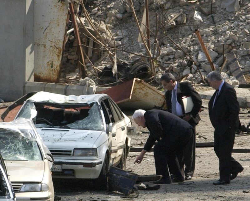 Irish Deputy Police Commisioner Peter Fitzgerald (L) head of a United Nations fact-finding team inspects the bomb scene February 26, 2005, where former Lebanese prime minister Rafik al-Hariri was killed in Beirut. A United Nations fact-finding team began inquiries on Friday into the assassination of former Lebanese Prime Minister Rafik al-Hariri, a killing the opposition blamed on Syria.Hariri's death inflamed a row over the presence of Syrian troops in Lebanon and intensified international pressure on Damascus to end its dominating role in its smaller neighbour.  REUTERS/Str