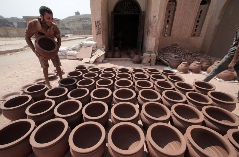 An Egyptian worker sorts clay pots to dry before displaying them for sale at one of the traditional pottery workshops in Old Cairo, Egypt. All photos: Khaled Elfiqi / EPA