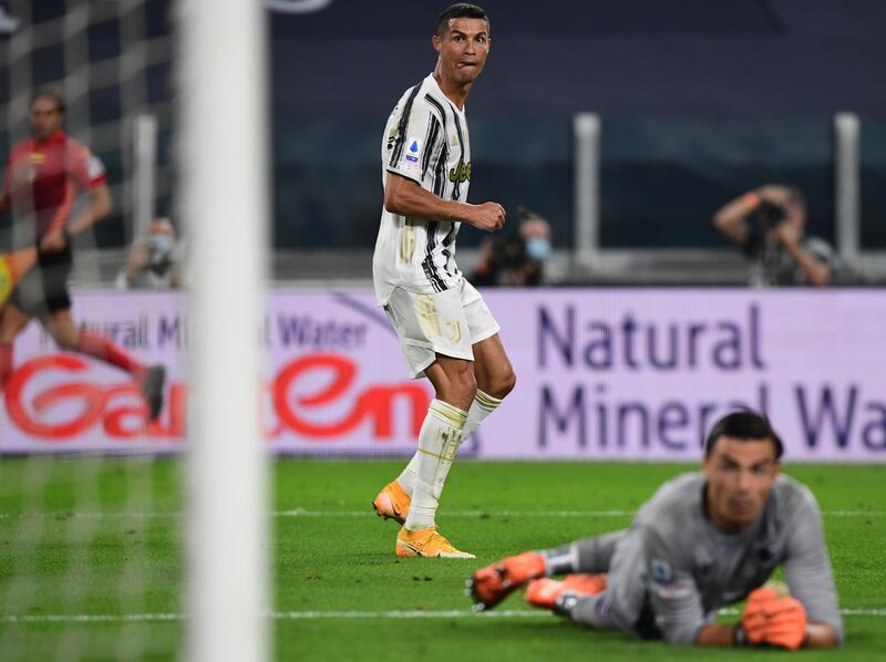 Juventus' Portuguese forward Cristiano Ronaldo looks on as he scores his team's third goal past Sampdoria's Italian goalkeeper Emil Audero (Bottom) during the Italian Serie A football match Juventus vs Sampdoria on September 20, 2020 at the Juventus stadium in Turin. (Photo by Miguel MEDINA / AFP)