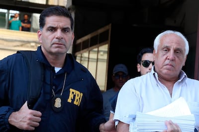 Suspect Tommaso Inzerillo, right, is taken into custody during an anti-mafia operation lead by the Italian Police and the FBI in Palermo, Southern Italy, Wednesday, July 17, 2019. Italian police and the FBI arrested 19 suspected Mafiosi in a joint operation Wednesday following an investigation which revealed alleged ties between Sicily's Cosa Nostra Mafia and New York's Gambino crime family. (Igor Petix/ANSA Via AP)