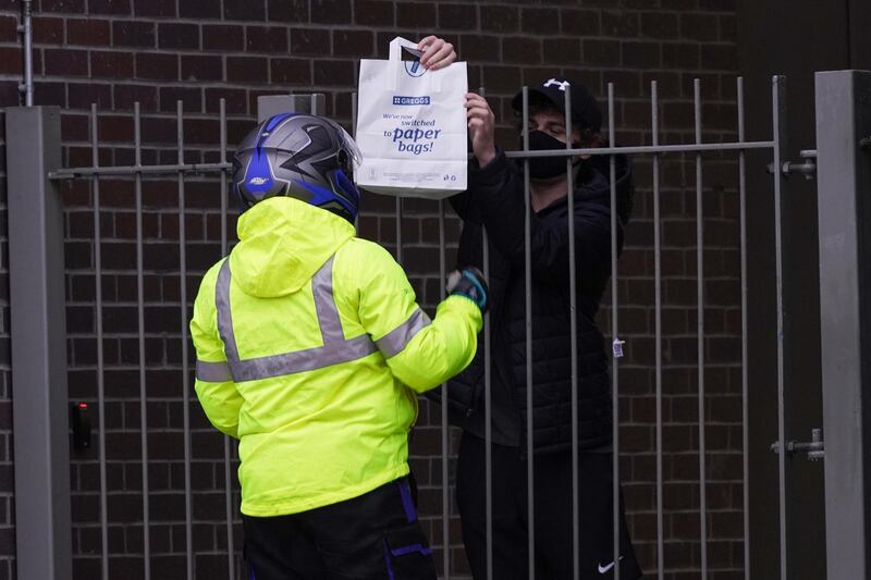 A student takes delivery of take away food near Northumbria University. The university said 770 of its students have tested positive for Covid-19, in one of the UK’s largest single-site coronavirus outbreaks. Ian Forsyth / Getty