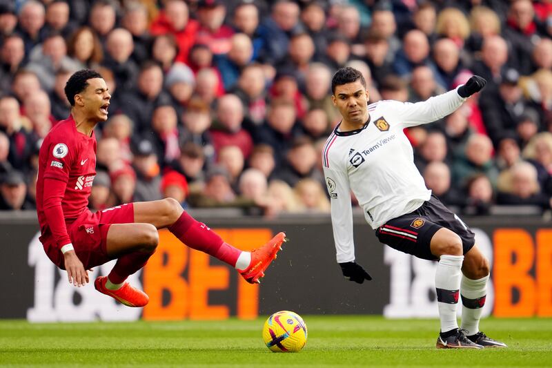 Liverpool's Cody Gakpo is challenged by Manchester United's Casemiro. AP
