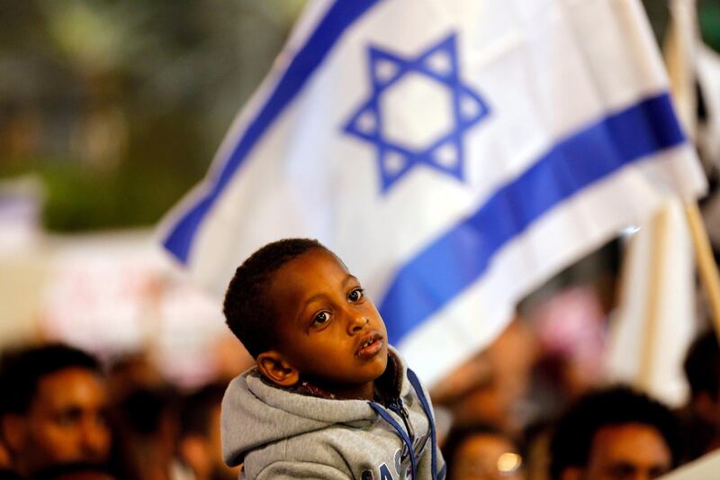 FILE PHOTO: A boy takes part in a protest against the Israeli government's plan to deport African migrants, in Tel Aviv, Israel March 24, 2018. REUTERS/Corinna Kern/File Photo