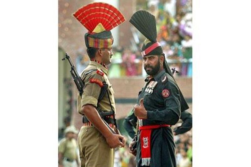 An Indian and a Pakistani soldier take part in the Beating the Retreat ceremony at Wagah, on the two countries' border.