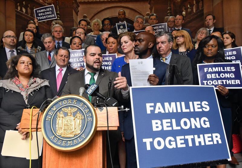 Assemblyman Marcos Crespo, D-Bronx, center,stands with members of the New York Assembly Democratic Conference calling for an immediate end to the Trump White House policy of family separation for migrants crossing the US-Mexico border, during a rally at the state Capitol on the last scheduled day of the 2018 legislative session Wednesday, June 20, 2018, in Albany, N.Y. (AP Photo/Hans Pennink)