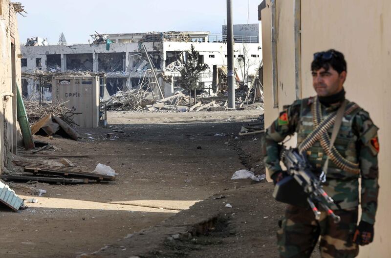 epa08061847 An Afghan security official stands guard at the scene of a car bombing near the US Bagram Air Base in Bagram, Afghanistan, 11 December 2019. At least five people were injured and an under-construction hospital close to the airfield was damaged. The attack, which has not been attributed to any group so far, came shortly after the Taliban and the US resumed peace talks in Doha, Qatar.  EPA/HEDAYATULLAH AMID