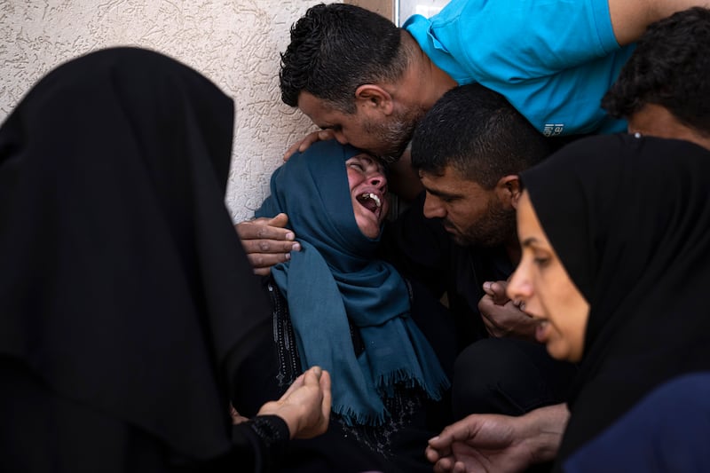 Palestinians mourn for a man killed in an Israeli air strike in Khan Younis in the Gaza Strip. AP