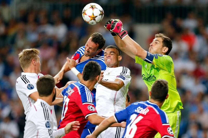 MADRID, SPAIN - SEPTEMBER 16: Iker Casillas (R) of Real Madrid clears the ball during the UEFA Champions League group B match between Real Madrid and FC Basel 1893 at Estadio Santiago Bernabeu on September 16, 2014 in Madrid, Spain. (Photo by Victor Carretero/Real Madrid via Getty Images)
