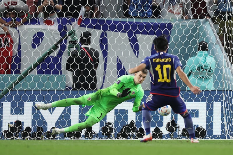 Croatia goalkeeper Dominik Livakovic saves from Takumi Minamino of Japan during the penalty shoot-out. Getty