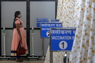 epa08974346 A woman waits for her turn to receive a COVID-19 vaccine shot inside the vaccination centre at Shatabdi Hospital in Mumbai, India, 30 January 2021.  EPA/DIVYAKANT SOLANKI