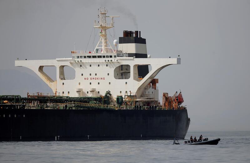 FILE PHOTO: Gibraltar defence police officers guard the Iranian oil tanker Grace 1 as it sits anchored after it was seized earlier this month by British Royal Marines off the coast of the British Mediterranean territory on suspicion of violating sanctions against Syria, in the Strait of Gibraltar, southern Spain July 20, 2019. REUTERS/Jon Nazca/File Photo