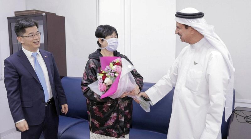 Liu Yujia, the first person in the UAE to recover from coronavirus is congratulated by Consul General Li Xuhang of China and Dr Hussein Al Rand, assistant undersecretary of the Ministry of Health and Prevention, February 9, 2020. WAM
