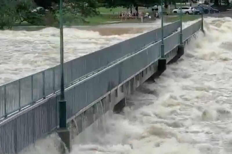 Floodwater flows by the Aplins Weir Rotary Park footbridge in Mundingburra district, Townsville. Reuters