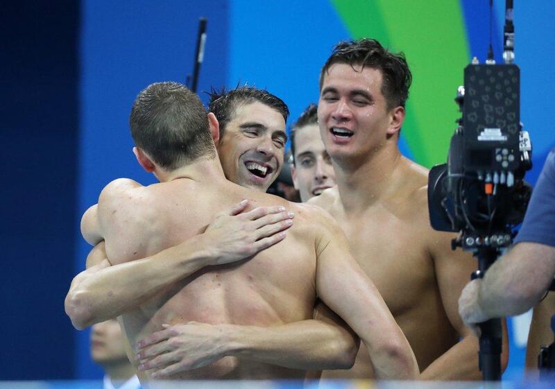 Michael Phelps (2-L) of USA is hugged by teammates after winning the men’s 4x100m medley relay final race of the Rio 2016 Olympic Games Swimming events at Olympic Aquatics Stadium at the Olympic Park in Rio de Janeiro, Brazil, 13 August 2016. Esteban Biba / EPA