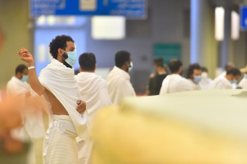 A Muslim pilgrim wearing a face mask casts stones at pillars symbolizing the devil during the annual Hajj pilgrimage. Saudi Ministry of Media / Reuters