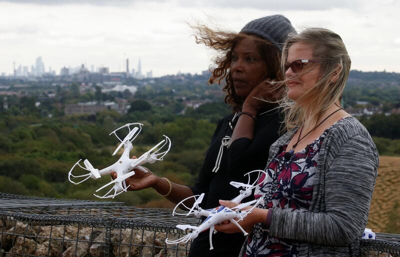 Activists Valerie Milner-Brown and Linda Davidsen pose with drones near Heathrow Airport in London, Britain, September 12, 2019. REUTERS/Henry Nicholls