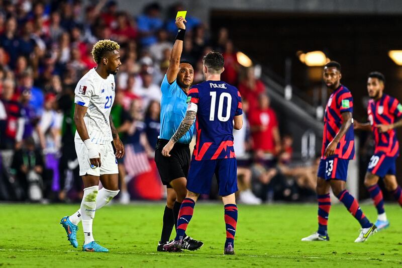Referee shows Christian Pulisic a yellow card. AFP