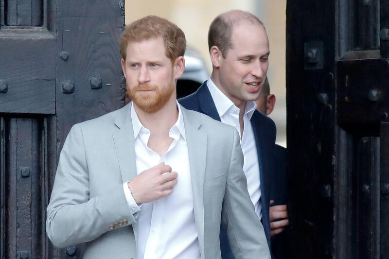 (FILES) In this file photo taken on May 18, 2018 Britain's Prince Harry (L) and his best man Prince William, Duke of Cambridge, (R) arrive to greet well-wishers on the street outside Windsor Castle in Windsor, on the eve of Prince Harry's royal wedding to US actress Meghan Markle.  Britain's Prince Harry said he and his brother Prince William were on "different paths" and admitted occasional tension in their relationship. The Duke of Sussex, 35, has been plagued by rumours of a growing rift between him and 37-year-old William, and he acknowledged that "inevitably stuff happens" given their high-profile roles in the royal family. In an interview with ITV television filmed during his recent tour of southern Africa with his wife Meghan, Harry said: "We are brothers. We will always be brothers. / AFP / Tolga AKMEN

