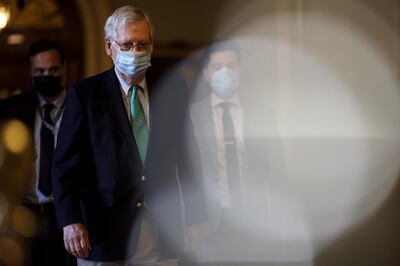 Senate Majority Leader Mitch McConnell, a Republican from Kentucky, wears a protective mask while walking the U.S. Capitol Building in Washington, D.C., U.S., on Saturday, Dec. 19, 2020. Congressional leaders are still working on a roughly $900 billion deal to help the U.S. economy weather the coronavirus pandemic, and trying to overcome the final disagreements that bogged down talks enough to miss a Friday deadline on a government spending measure. Photographer: Ting Shen/Bloomberg