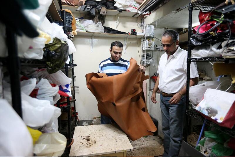 The manager of Golden Shoes Shop, Mohammed Ahmed, and Saif Al Deen Ahmed. The two Syrian shoemakers have lived in Abu Dhabi for over 11 years. Fatima Al Marzooqi / The National