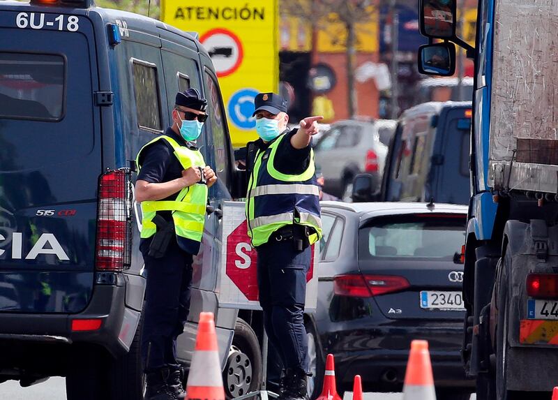 A French and a Spanish police officer talk at the French-Spanish border in Behobie, south-west France. AP Photo