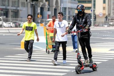 Electric scooters are popping up across Abu Dhabi with more than 100,000 users in the emirate. Victor Besa / The National    