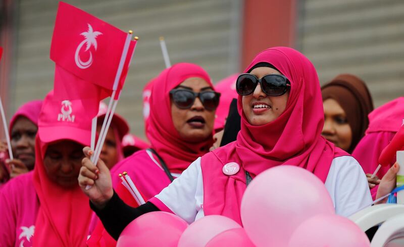 Supporters of Maldivian President Yameen Abdul Gayoom cheer as they take part in a street parade in Male, Maldives, Saturday, Sept. 22, 2018. (AP Photo/Eranga Jayawardena)