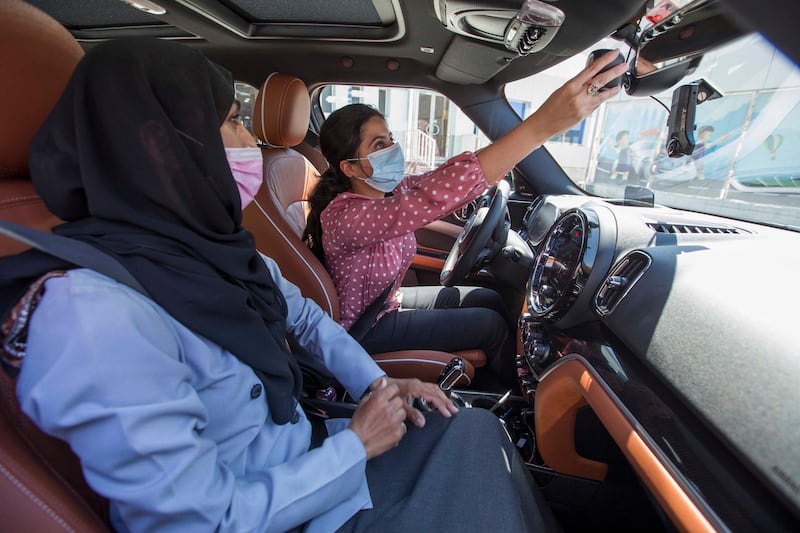 Dubai, United Arab Emirates - Instructor Sabia teaching a students pointers in driving at the Emirates Driving Institute, Dubai.  Leslie Pableo for The National