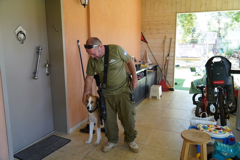 Lior Shelef with his Caananite dog Macha, in front of his home in Kibbutz Snir near the Israel Lebanon border