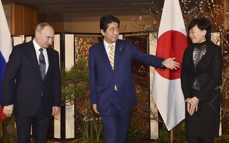 Russian president Vladimir Putin, left, is greeted by Japanese prime minister Shinzo Abe, centre, and his wife, Akie, upon his arrival at a hot springs resort for a meeting in Nagato, Japan on December 15, 2016. Kazuhiro Nogi/Pool Photo via AP