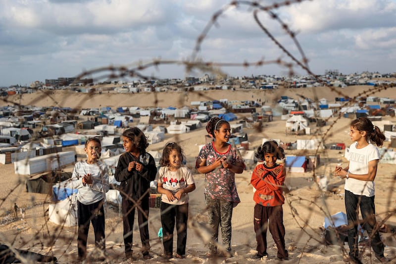Children near a camp housing displaced Palestinians in Rafah last month. AFP