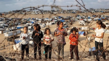 Children near a camp housing displaced Palestinians in Rafah last month. AFP