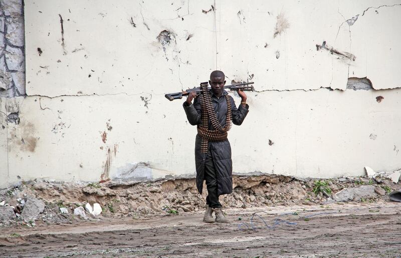 A Somali soldier stands at the scene of a suicide car bomb near the port in Mogadishu. AP Photo