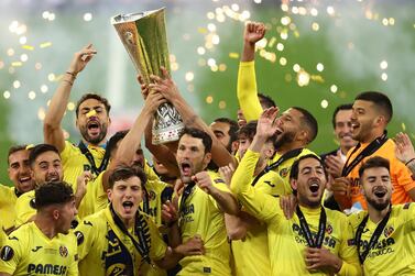 epa09230316 Players of Villarreal celebrate with the trophy after winning the UEFA Europa League final soccer match between Villarreal CF and Manchester United in Gdansk, Poland, 26 May 2021. EPA/Maja Hitij / POOL