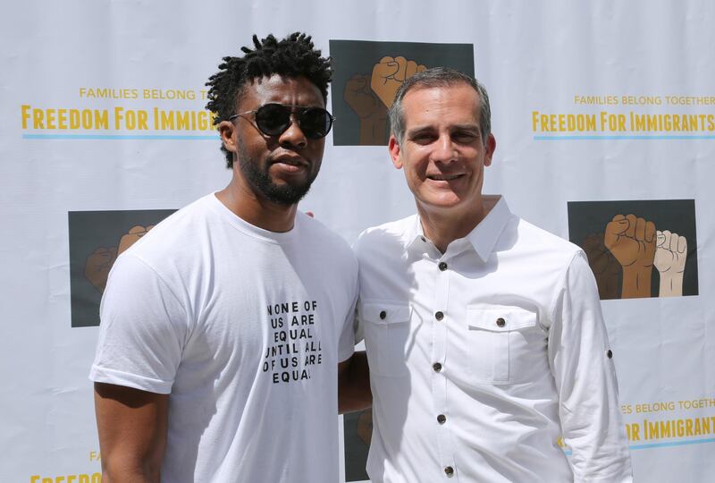 Chadwick Boseman, left, and Los Angeles Mayor Eric Garcetti attend the "Families Belong Together: Freedom for Immigrants" March. Willy Sanjuan / Invision / AP