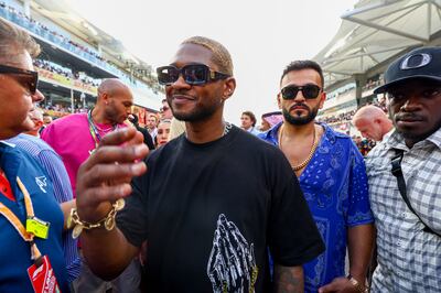 Usher walks on the grid prior to the F1 Abu Dhabi Grand Prix at Yas Marina Circuit. Getty Images